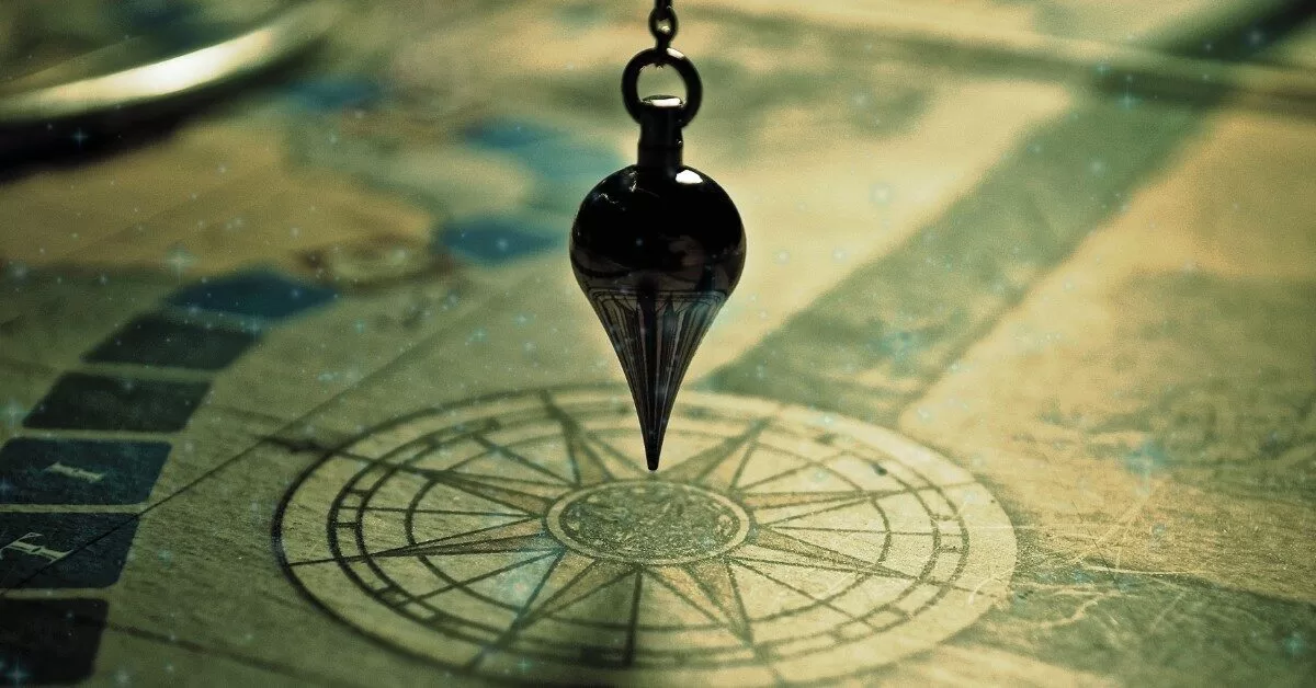 A magical black pendulum hangs over a softly glowing compass rose on a parchment map, suggesting hidden paths and enchanted navigation through the Veil.