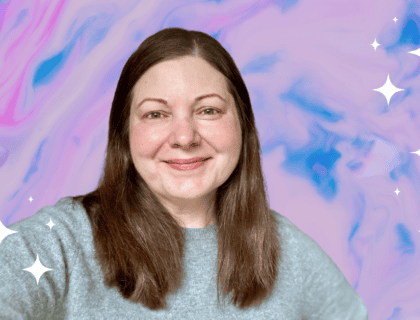 Picture of Tera Lynn Childs smiling and wearing a gray sweater against a swirling marble blue, pink, and purple background.