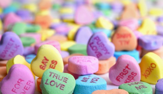 A pastel-rainbow-colored picture of Valentine's Day favorite candy conversation hearts.